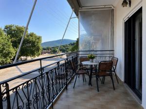 a balcony with a table and chairs and a view at Dimitris house in Parga