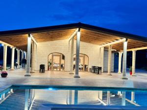 a building with a pool in front of it at Agriturismo Tenuta Santarcangelo in Scanzano
