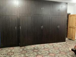 a group of wooden cabinets in a room at Visiting Villa in Srinagar +38 photos