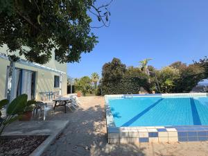 a swimming pool in front of a house at Queen Evridiki in Peyia