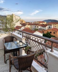 a table and chairs on a balcony with a view at Hotel Fineso in Budva