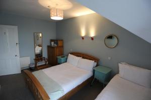 Postel nebo postele na pokoji v ubytování Rolling Wave Guesthouse
