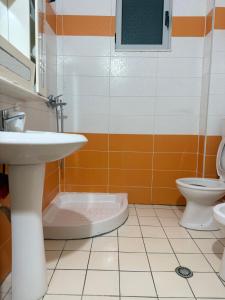 a bathroom with a sink and a toilet at AS Orikum 2 in Orikum
