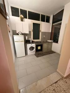 a kitchen with a refrigerator and a washing machine at Orange Home in Olbia