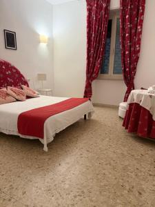a bedroom with a bed with red curtains at Orange Home in Olbia