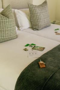a close up of a bed with a green blanket at Moditlo River Lodge in Hoedspruit