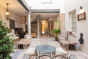an outdoor patio with a table and chairs at Apartamentos Luna Suites Palacio Almagra in Granada +16 photos