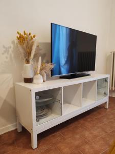 a white entertainment center with a television on it at Casa Vacanze Del Pescatore in Passignano sul Trasimeno