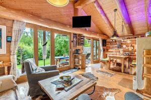 a log cabin living room with a wooden ceiling at Ferienhütte 15 in Sankt Englmar