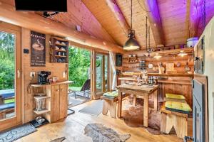 a kitchen with wooden walls and a wooden table at Ferienhütte 15 in Sankt Englmar