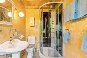 a bathroom with a shower and a sink and a toilet at Ferienhütte 15 in Sankt Englmar +28 photos