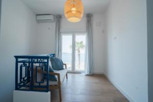 a living room with a table and a chair at Casa Las Conchas in La Rábita