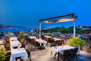 a restaurant with tables and chairs on a balcony at Levni Hotel & SPA - Special Category in Istanbul