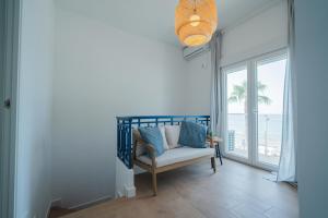 a living room with a chair and a view of the ocean at Casa Las Conchas in La Rábita