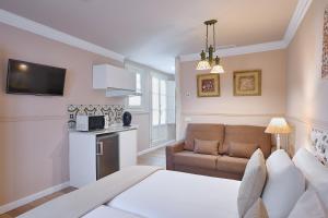 a living room with a bed and a couch at Apartamentos Luna Suites Palacio Almagra in Granada