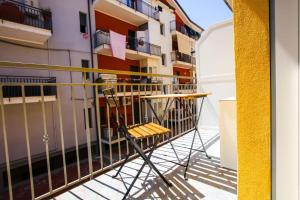 a table and chairs on a balcony of a building at Pole Pole - NATURA in Agropoli