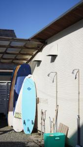 two surfboards are parked next to a building at PavilionSurf&Lodge in Shishikui