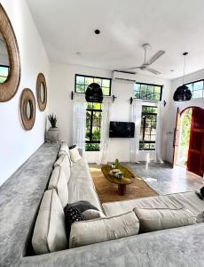 a living room with a large couch and a table at Casa Mysa Villas in Michamvi