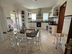 a kitchen with a dining room table and chairs at Casa Loureiro - Vista Rio Douro in Resende