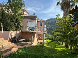 a house with a balcony and a patio at Casa Loureiro - Vista Rio Douro in Resende