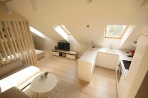 a living room with a couch and a table at Old Town Apartment with FREE Parking in Marijampolė