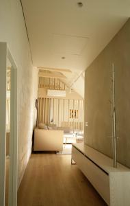 a living room with a couch and a bed at Old Town Apartment with FREE Parking in Marijampolė