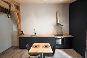 a kitchen with a wooden table and a sink at Oh la vache in Stoumont