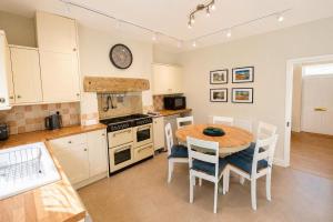 a kitchen with a table and chairs in a kitchen at Brookfield Cottages in Bakewell