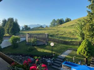 a garden with a gazebo in the grass at Gästehaus Grieser in Hopferau