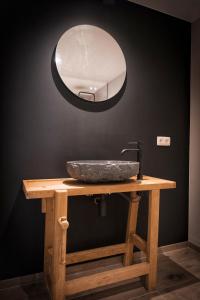 a bathroom sink with a mirror on a table at Oh la vache in Stoumont +1 photo