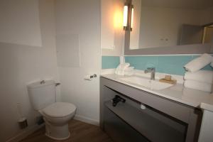 a bathroom with a toilet and a sink at La Mirande in Collioure