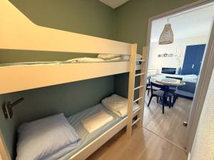 a room with two bunk beds and a table at La Mirande in Collioure +2 photos