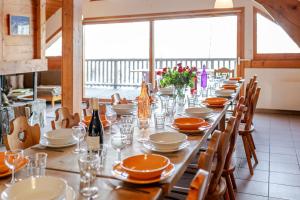 a long table with plates and wine glasses on it at LesChalets de Pré Genty in Oz