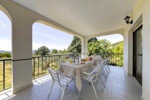 a dining room with a table and chairs on a balcony at Villa-Piedralaves-aMatalasviñas-piscina-4 viviendas in Piedralaves