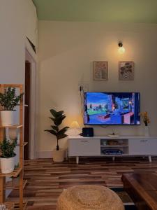 a living room with a large flat screen tv at Sunshine Stays in Siliguri