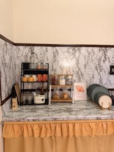 a counter top with a table with food on it at Sunshine Stays in Siliguri