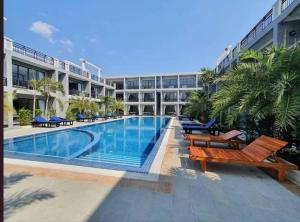 a large building with a swimming pool in front of a building at Khemra Boutique in Kampot in Kampot