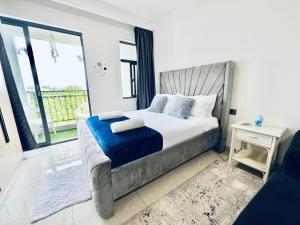 a bedroom with a bed and a large window at Nyvin Haven at The Loftel in Ruaka +16 photos