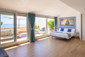 a bedroom with a bed and a view of the ocean at Suites At Sea II in Villajoyosa