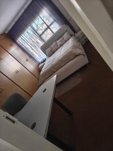 a small bedroom with a bed and a window at The Corner Lounge - Lenasia in Lenasia +18 photos