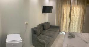 a living room with a chair and a bed at Erjani Hotel in Velipojë