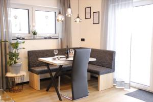 a dining room with a table and a chair at Kapellenblick Auszeit mit Ausblick in Heroldstatt