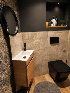 a bathroom with a sink and a mirror at Apartman Volosko in Opatija