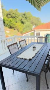 a blue picnic table with a spider sitting on it at Diving Apartments in Molunat