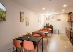 a restaurant with tables and chairs in a room at Almancil Hostel in Almancil