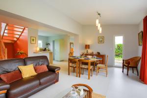 a living room with a couch and a table at La Houle in Créances