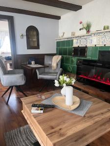 a living room with a fireplace and a table at Denkmal 1764 in Sasbachwalden