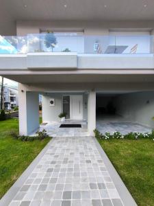 a large white house with a patio and grass at Suite Room 33 Ioannina - Near airport in Ioannina