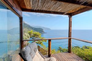 a room with a balcony with a view of the ocean at 11-11Shambala in Fethiye