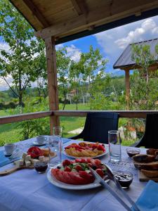 a table with plates of food on top of it at Hotel Restorant Natyra Diber Camping in Podgorcë